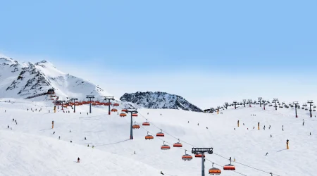 A long distance view of a cable car against white slopes in Sölden - Transfers