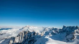 Snowy mountain peaks under a blue sky in the Alps