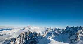 Snowy mountain peaks in Italy under a blue sky