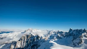 Snowy mountain peaks under a blue sky in the Alps