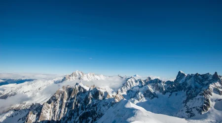 Snowy mountain peaks in Italy under a blue sky