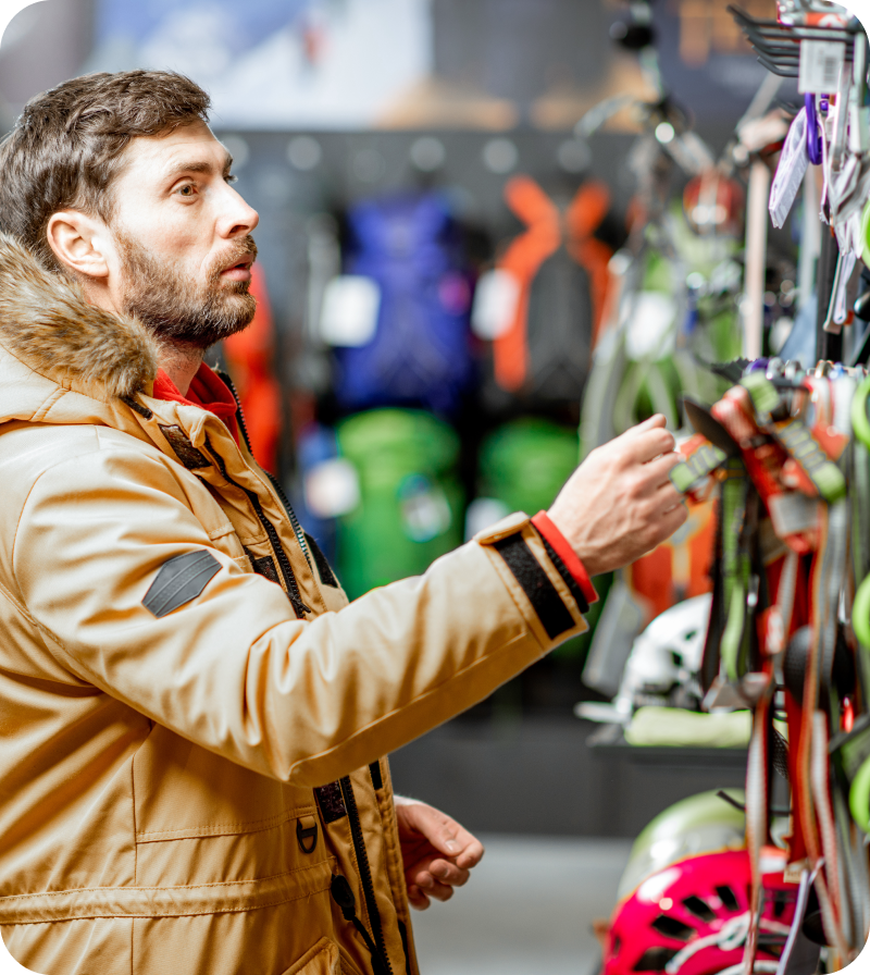 A man picking out ski gear at a ski rental shop