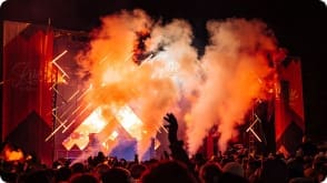 Image of smoke and a crowd at a ski festival