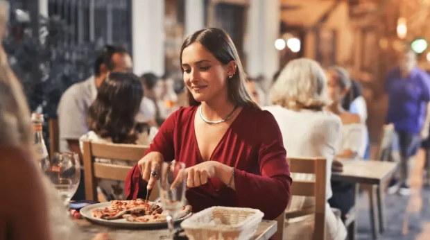 A woman eats dinner in an Alpine restaurant