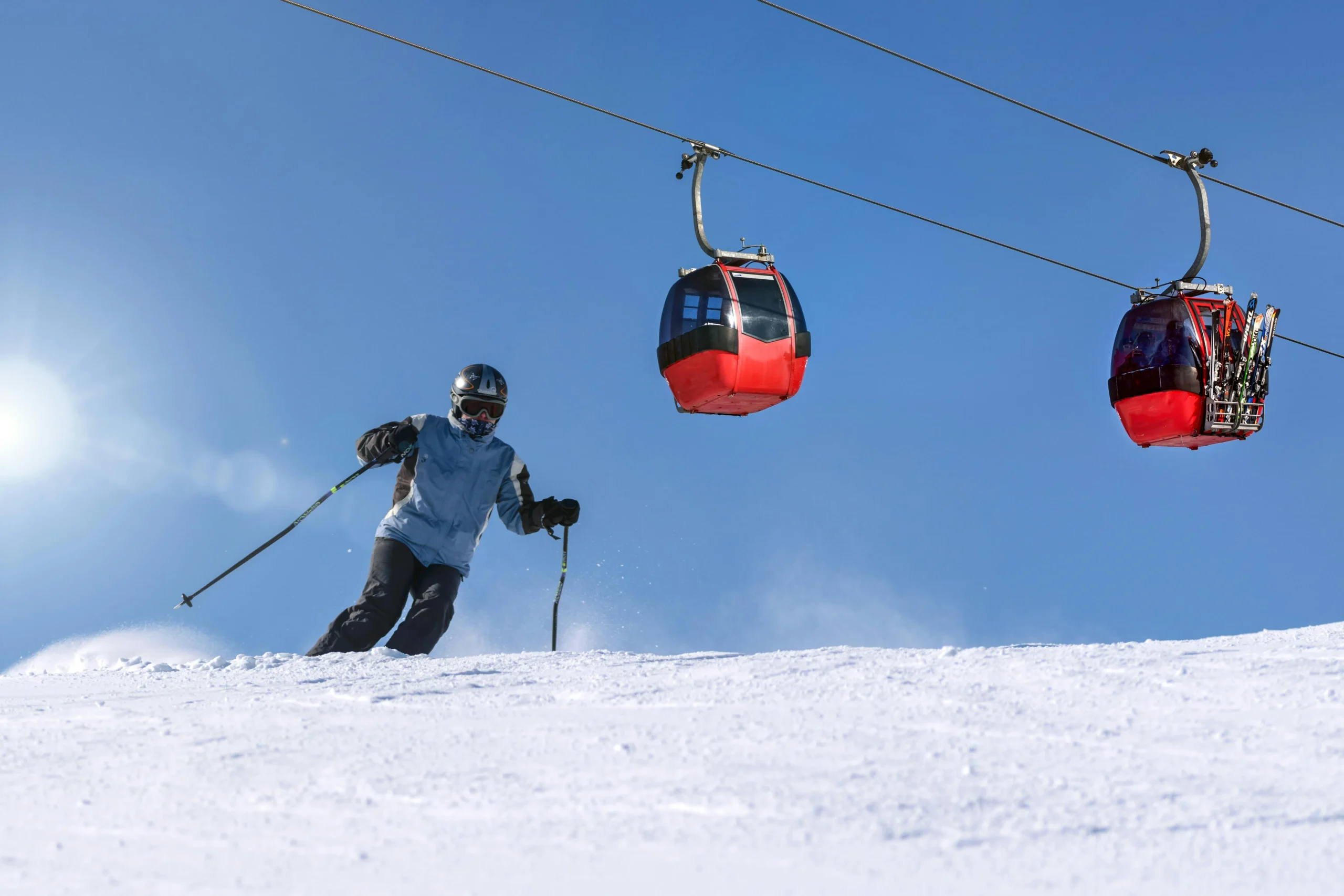 A skier by a cable car