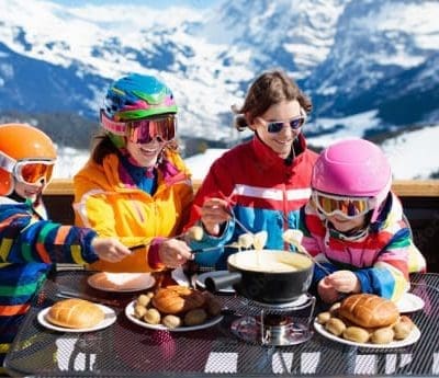 A family eating at an alpine restaurant on the slopes