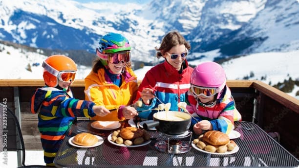 A family eating at an alpine restaurant on the slopes